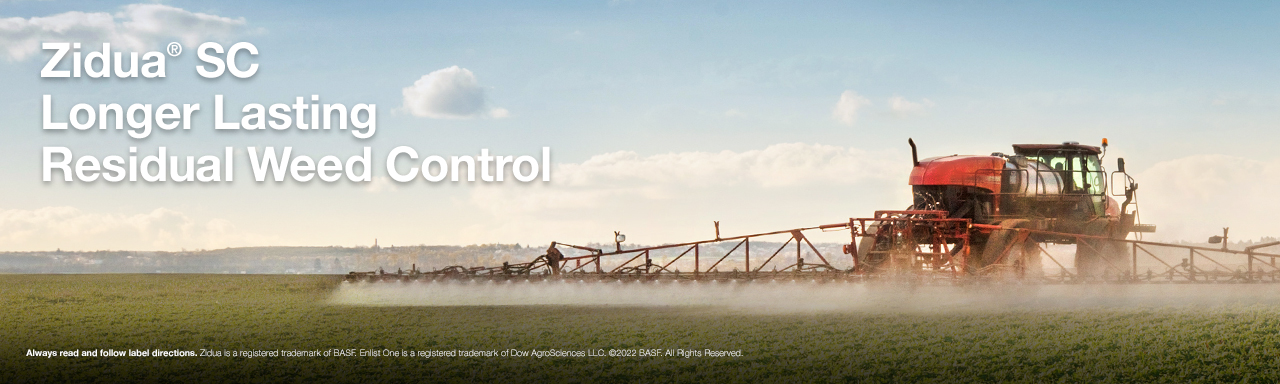 A red tractor spraying a field with the text, "Zidua SC Herbicide Named a Tank Mix Partner with Enlist One Herbicide"