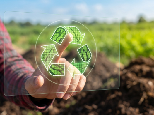 Recycling logo in front of a field