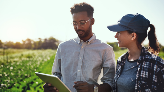 A young man and woman walking on a farm