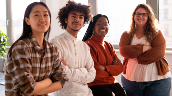 Four young people standing side by side