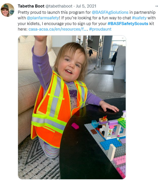 Tweet featuring a little girl in an orange vest