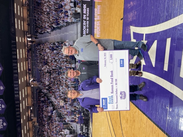 Three men holding a giant check