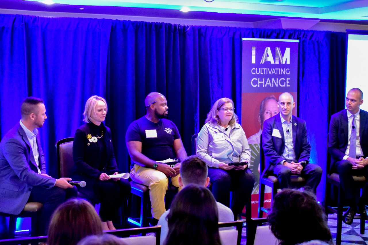 A group of men and women sitting on a panel